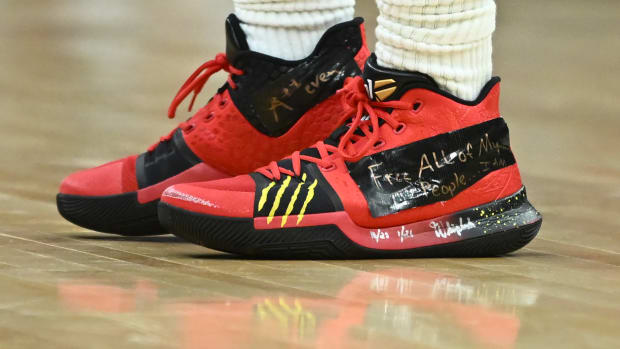View of red and black Nike Kyrie shoes.
